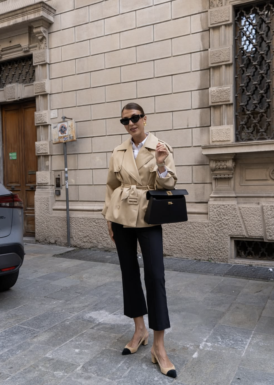 A fashion editor-approved outfit featuring black cropped pants paired with beige and black cap-toe block heels to create a clean, elongated ankle line.