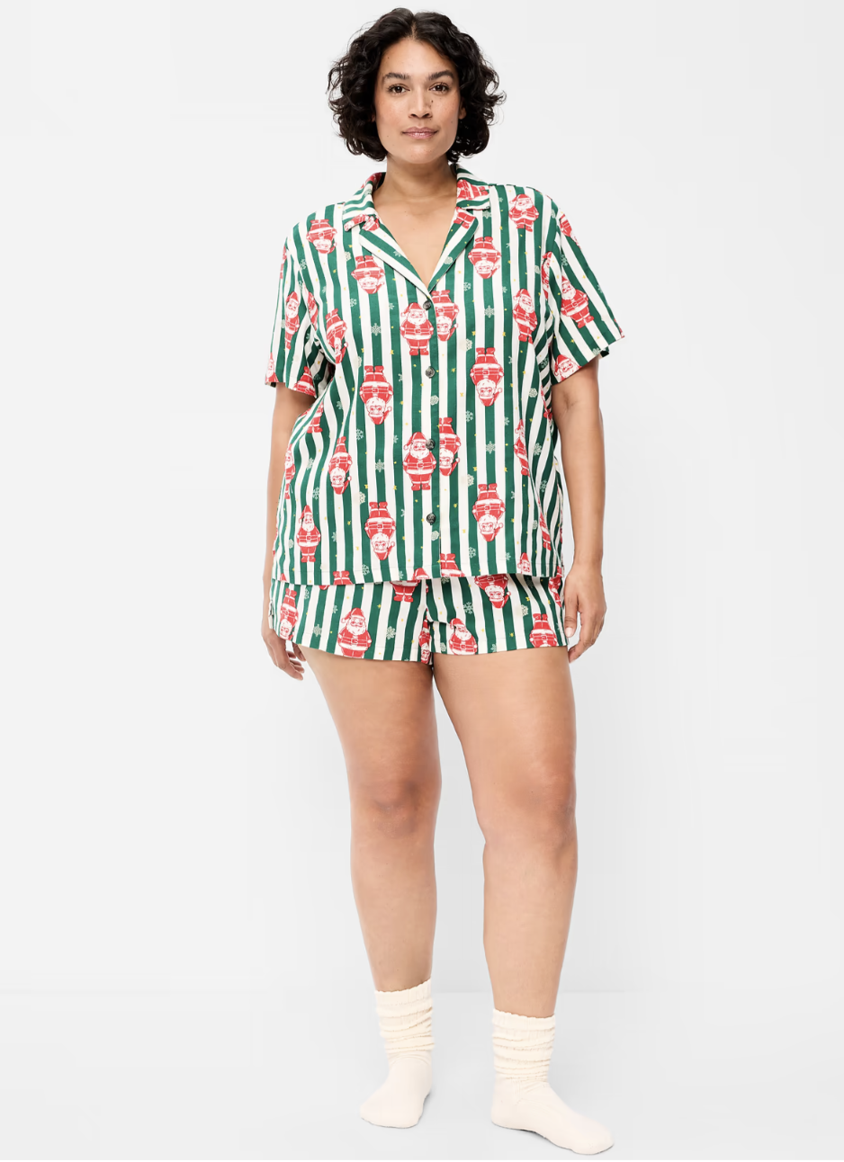 Woman wearing an Old Navy green and white striped Santa print flannel pajama set with a short-sleeve collared shirt and shorts