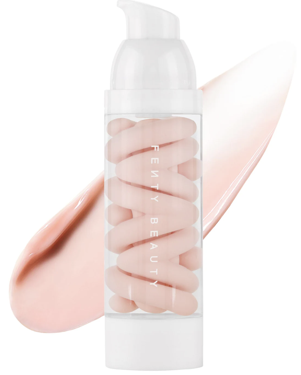 A close-up view of the Fenty Beauty Pro Filt'r Mattifying Primer bottle alongside a smooth swirl of the pink-toned cream product on a clean background.