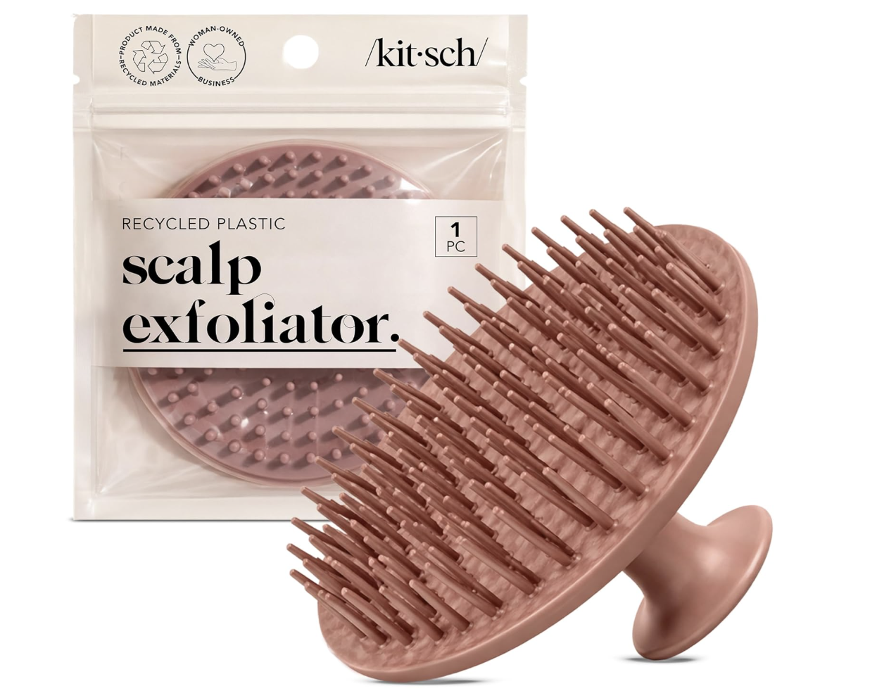 A Kitsch Scalp Exfoliator brush in a terracotta pink color next to its sustainable packaging, designed for deep cleaning and exfoliating natural hair on wash day.