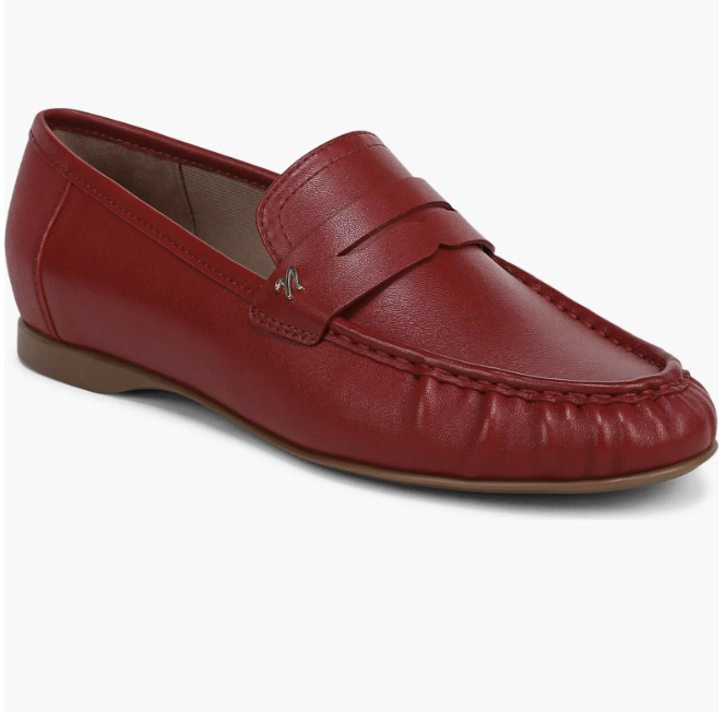 A pair of smooth red leather penny loafers with classic strap detailing and a low heel.