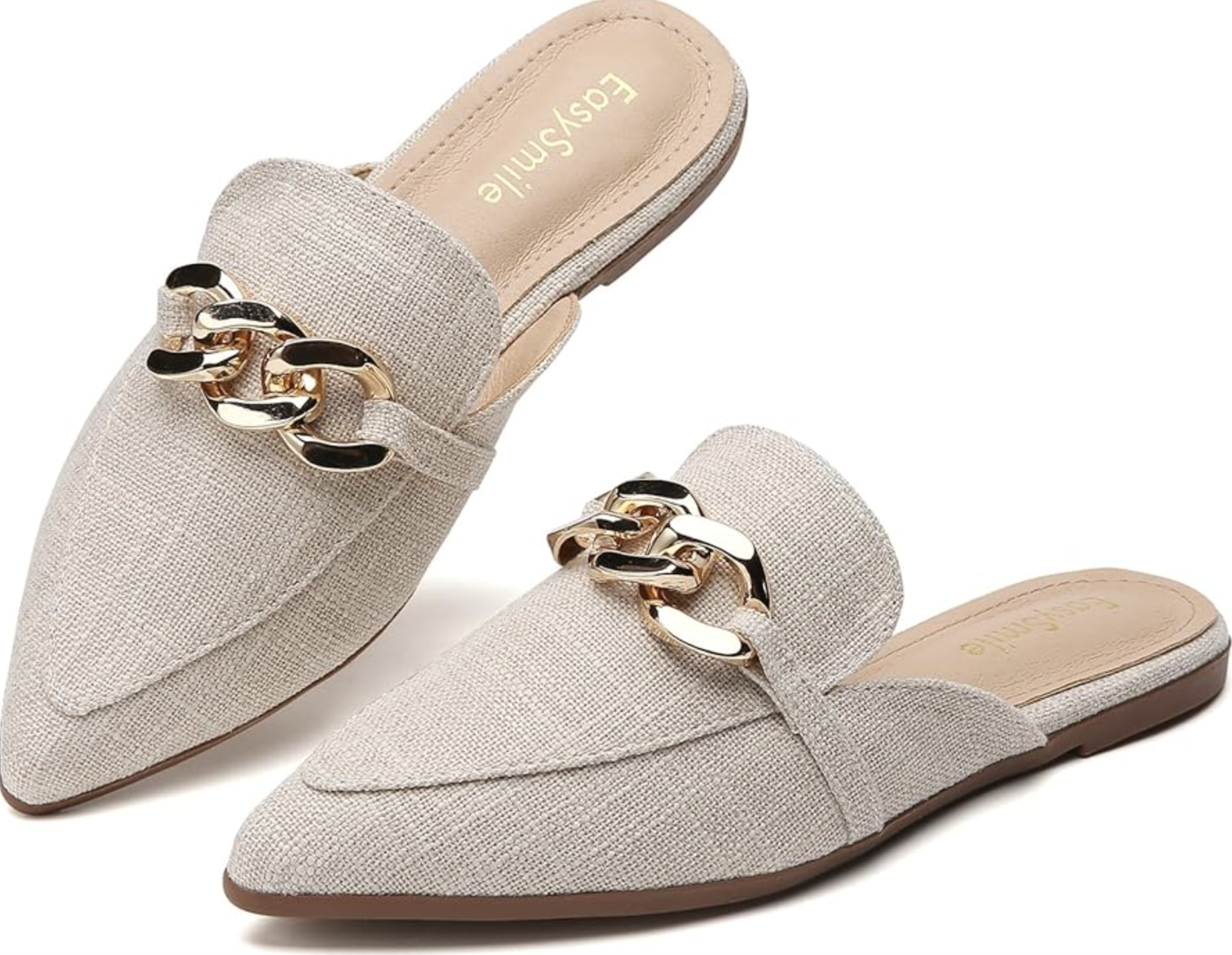 Close-up of a pair of beige textured-fabric pointed-toe mule loafers featuring a prominent gold chain link detail across the upper, styled as a flat slip-on shoe.