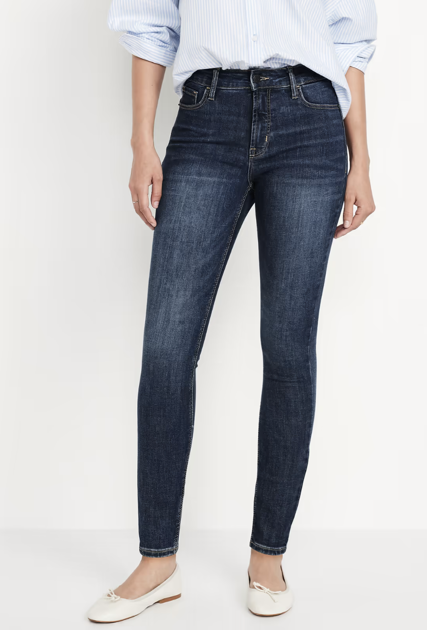 Woman wearing Old Navy Rockstar super-skinny jeans with a high waist and close-fitting leg.