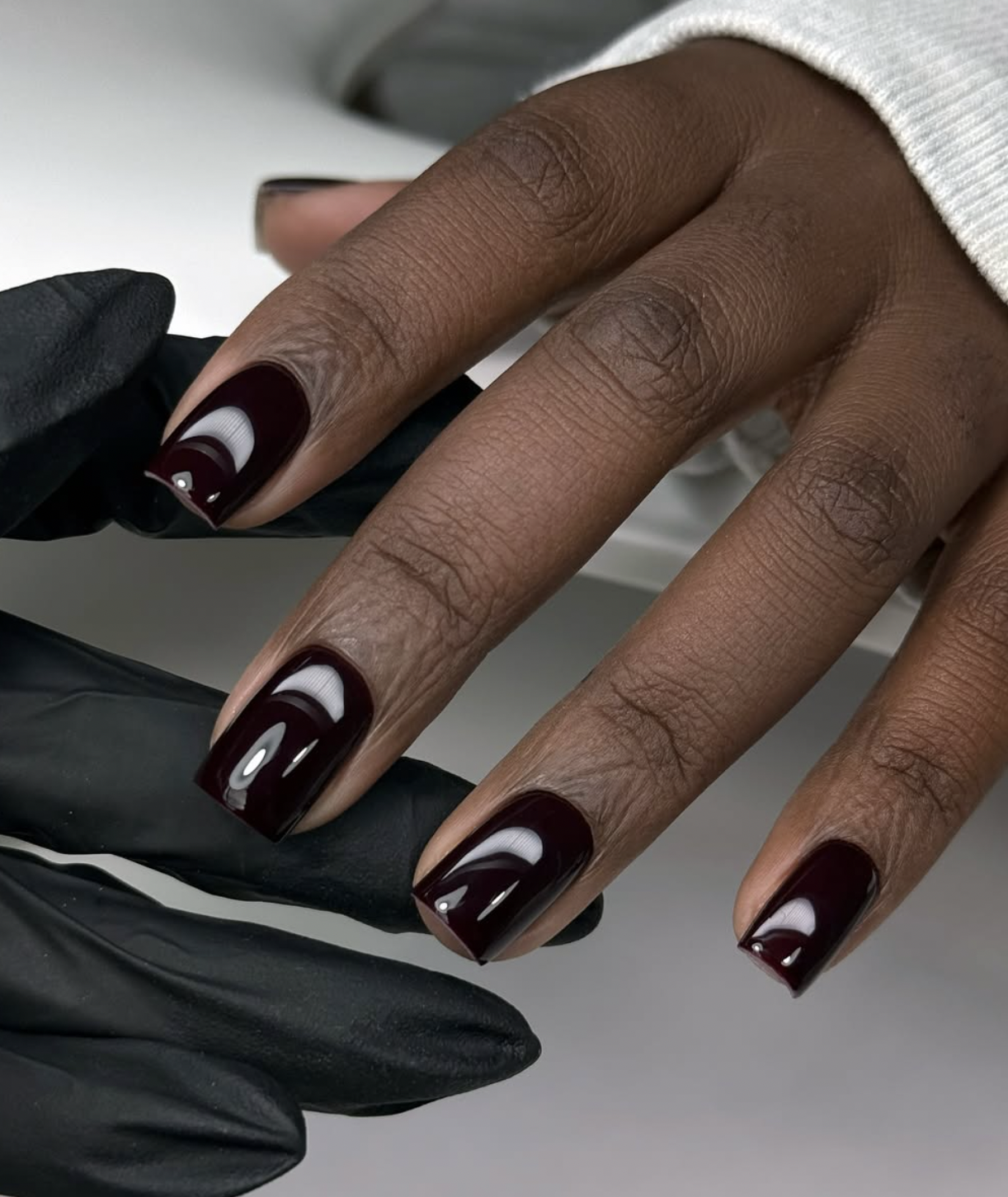 Deep black cherry nail polish with subtle red undertones