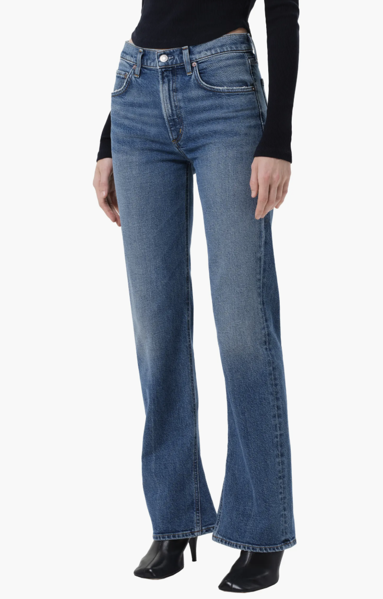 Product view of light-to-medium wash AGOLDE Kick bootcut jeans with a high-rise waist and a slight flare at the ankle.