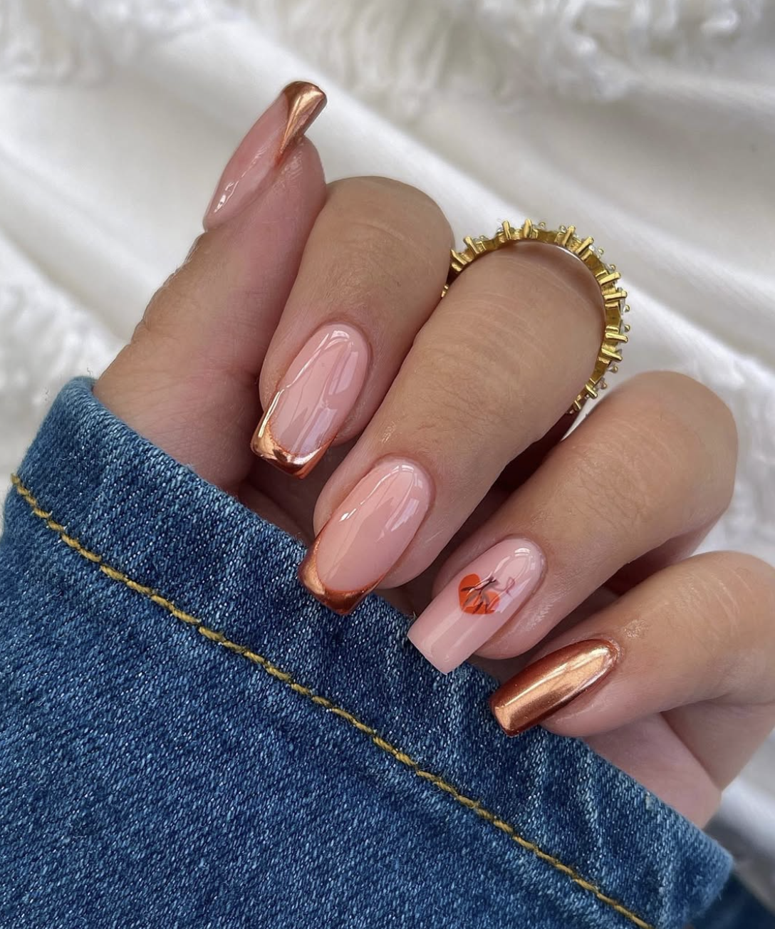 Close-up of pumpkin spice side french on neatly manicured hands
