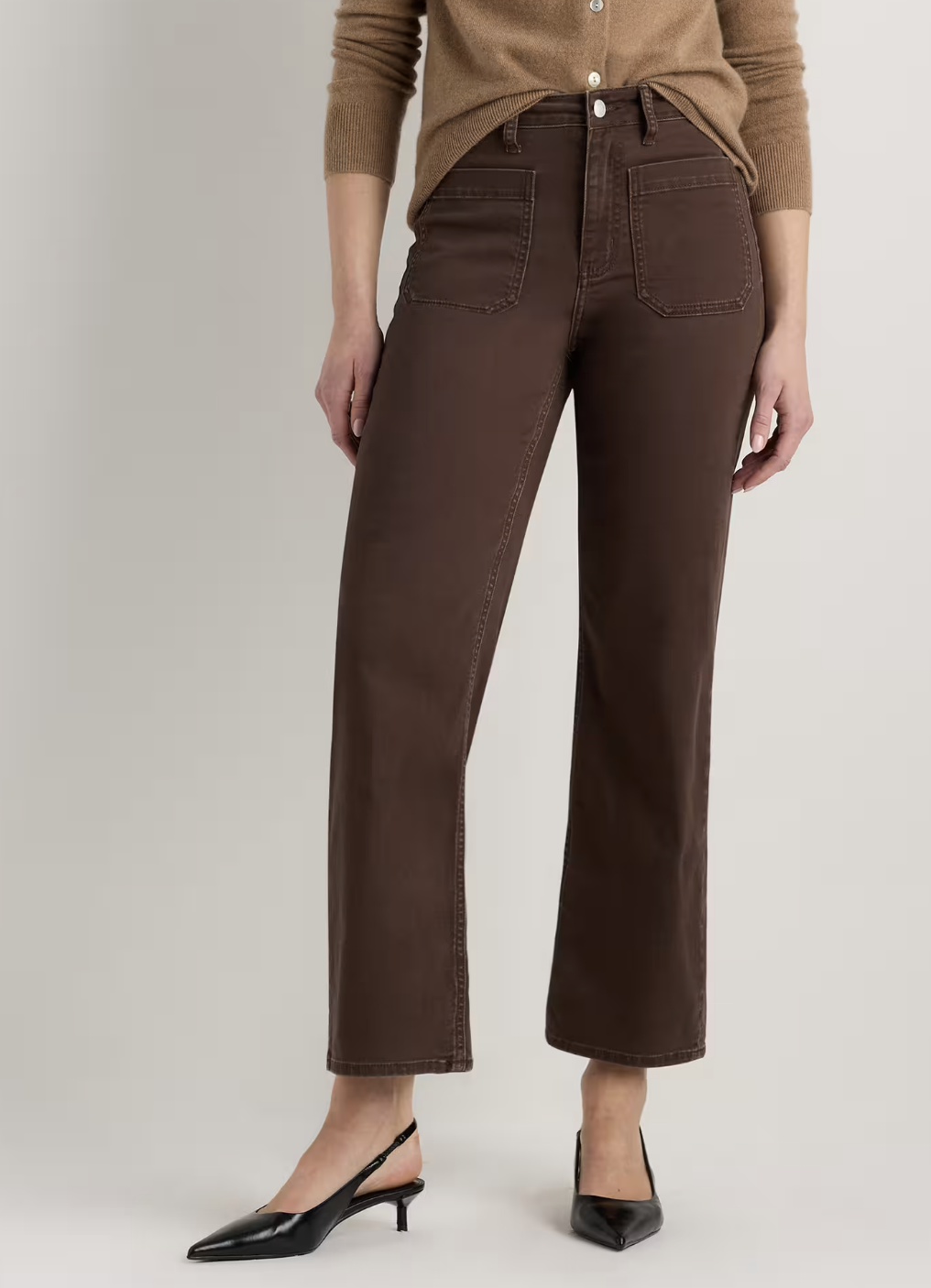 Chocolate brown high-waisted wide-leg trousers with slingback heels.