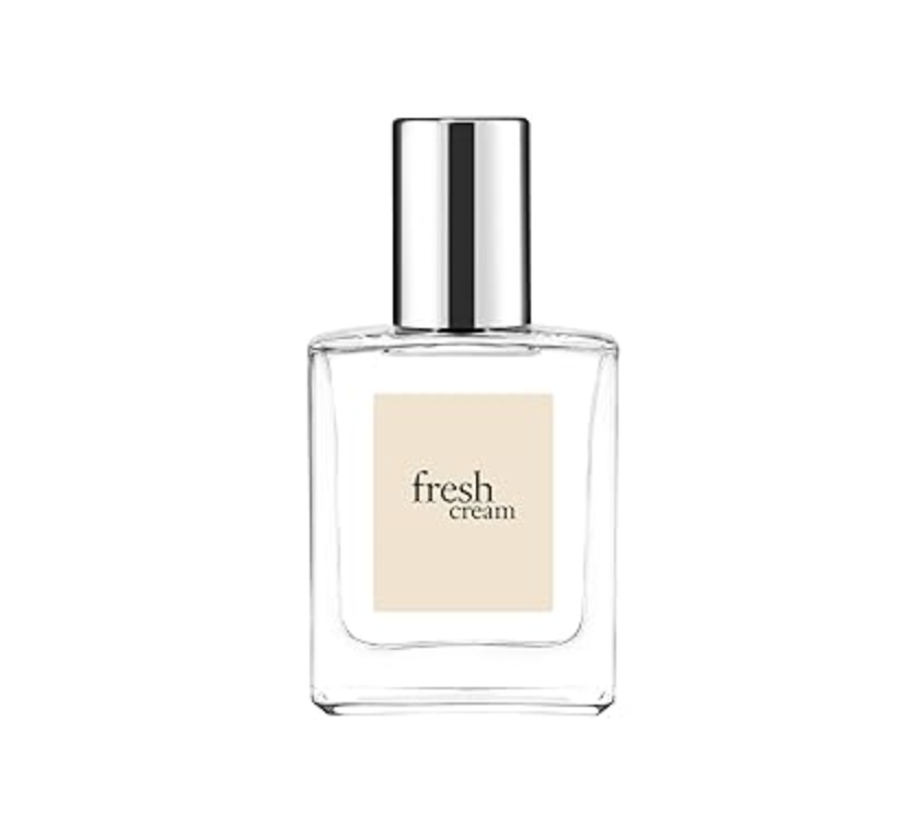A clear glass bottle of Philosophy Fresh Cream perfume with a white label and black text on a white background.