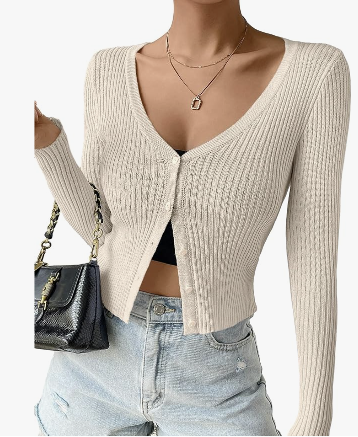 Professional traveler's pick: a cream-colored Amazon ribbed knit button-down cardigan, styled with light-wash jeans and gold layered necklaces for a wrinkle-free spring break evening.