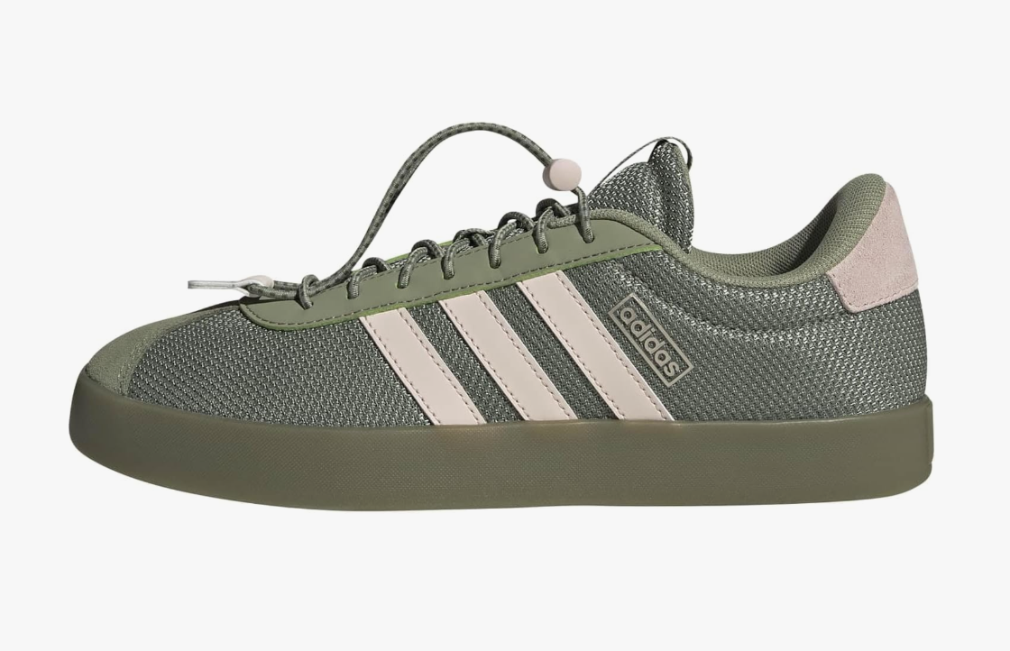 Olive green adidas VL Court 3.0 sneakers with white stripes, shown as a casual footwear option to pair with brown trousers.