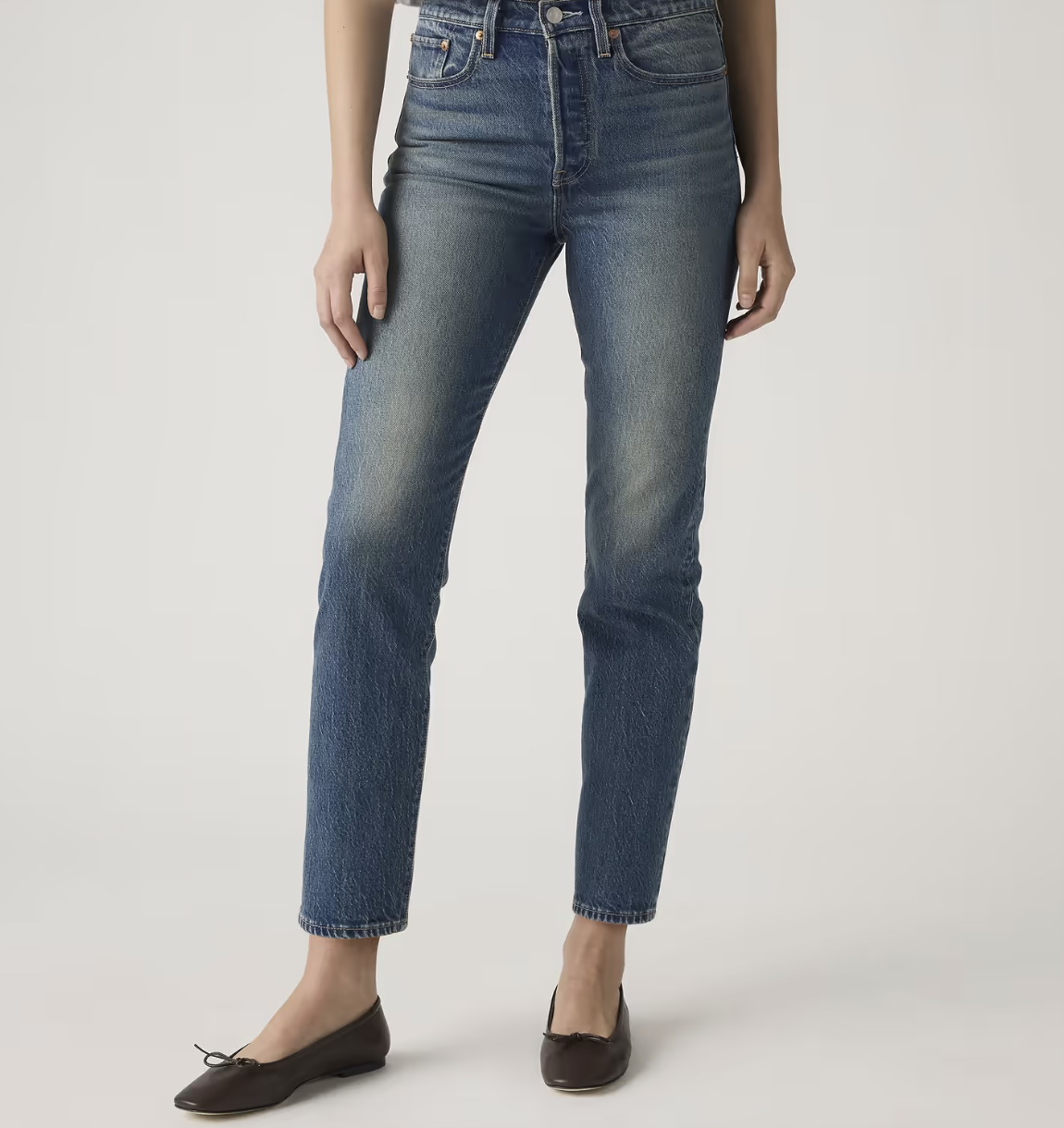 Rear view of Levi's Wedgie Straight Fit jeans in a medium wash, highlighting the high-set pockets and signature tilted yoke designed to lift the seat.