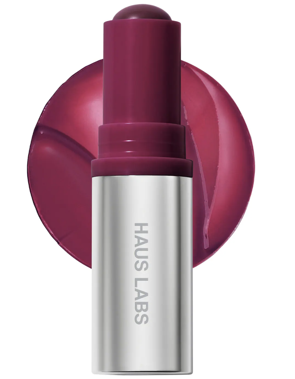 Haus Labs Color Fuse Longwear Hydrating Glassy Lip and Cheek Blush Balm Stick in a deep berry shade against a transparent background.