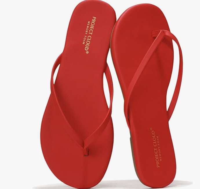 Fashion editor wearing vibrant red Project Cloud flip flops with a cushioned sole, demonstrating a comfortable and chic 2026 beach-to-street outfit formula.