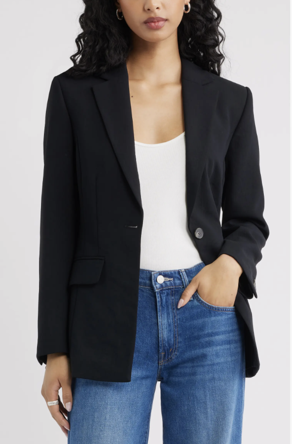 A close-up shot of a model wearing the Open Edit The Curator Fitted Blazer in black over a cream white knit tank top, highlighting a polished and structured fall layer.
