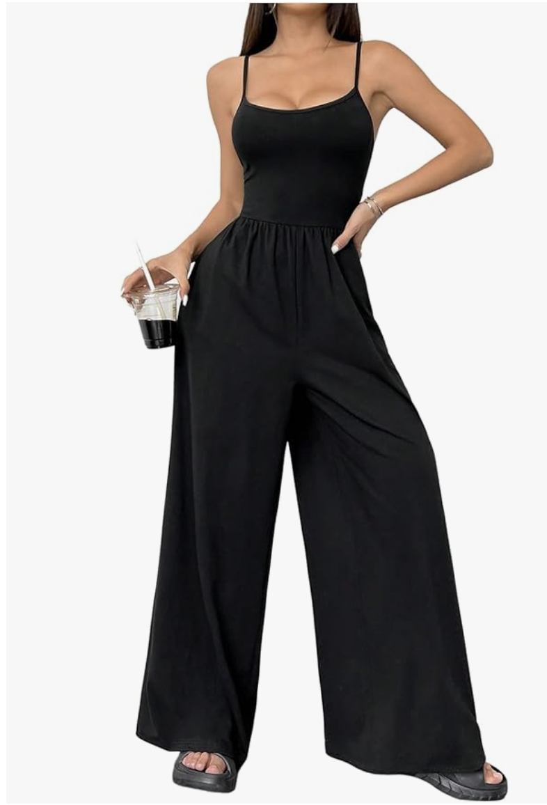 A minimalist front view of a black, loose-fitting wide-leg women's one-piece jumpsuit with delicate spaghetti straps.