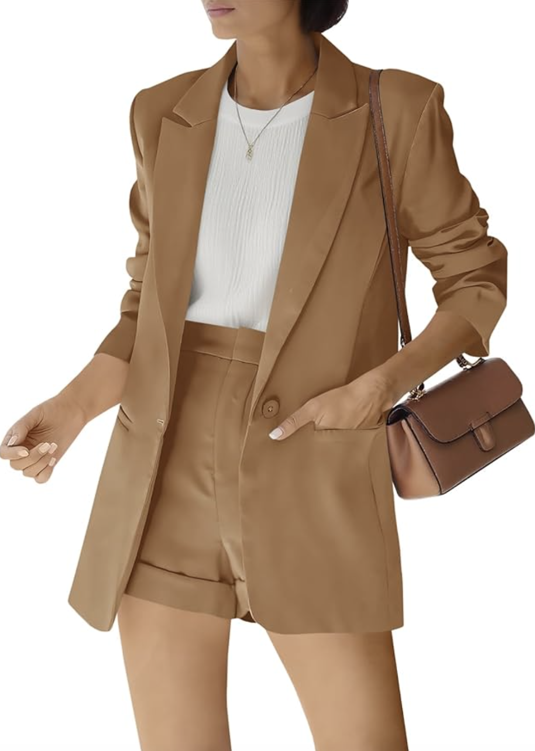 A woman wearing a coordinated beige oversized blazer and matching high-waisted tailored shorts, styled with a white top for a modern monochrome look.