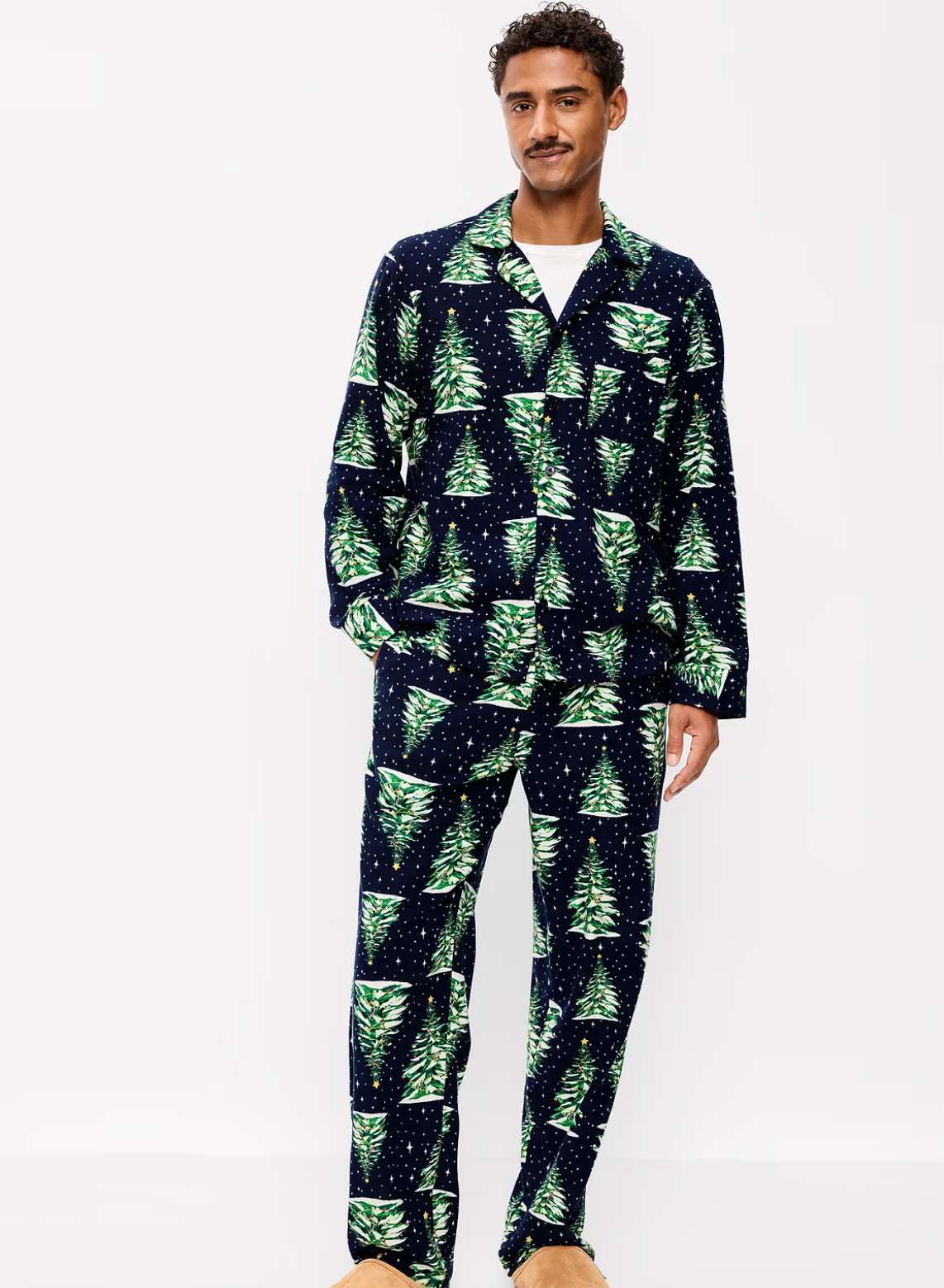 Man wearing an Old Navy navy flannel pajama set with a green Christmas tree print, a collared button-front shirt and matching pants