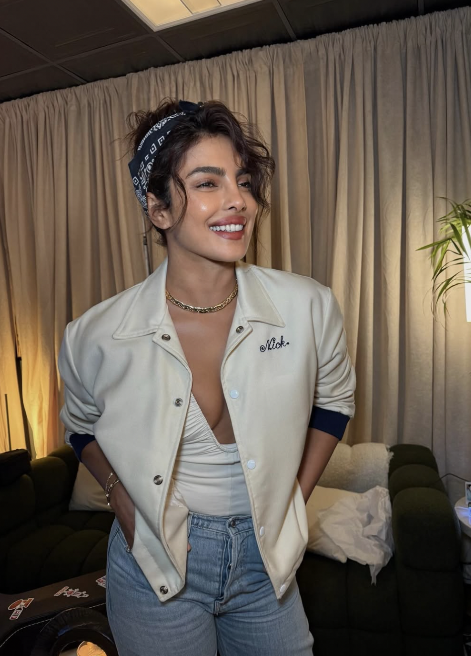 Priyanka Chopra wearing a creamy warm-white jacket and a neutral-toned top, demonstrating how clear, warm-based neutrals harmonize with a golden-medium complexion in the True Spring season.