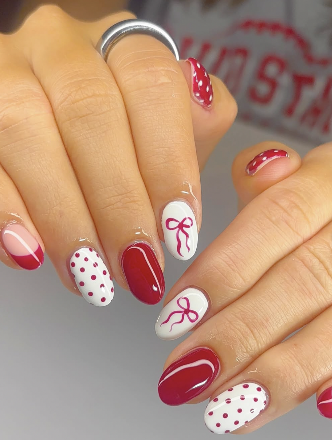 Short milky white Christmas nails with small red bows