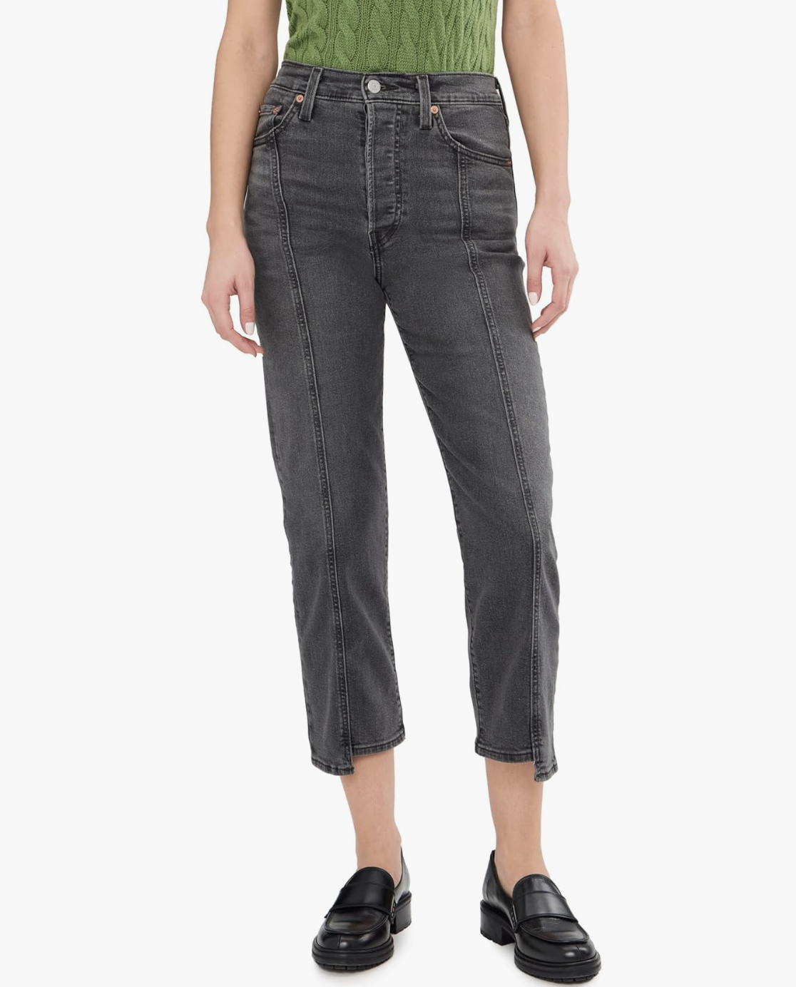 A person wearing dark grey Levi’s Ribcage Straight Ankle jeans with visible front seams and a high-waisted fit, paired with a green knit top.