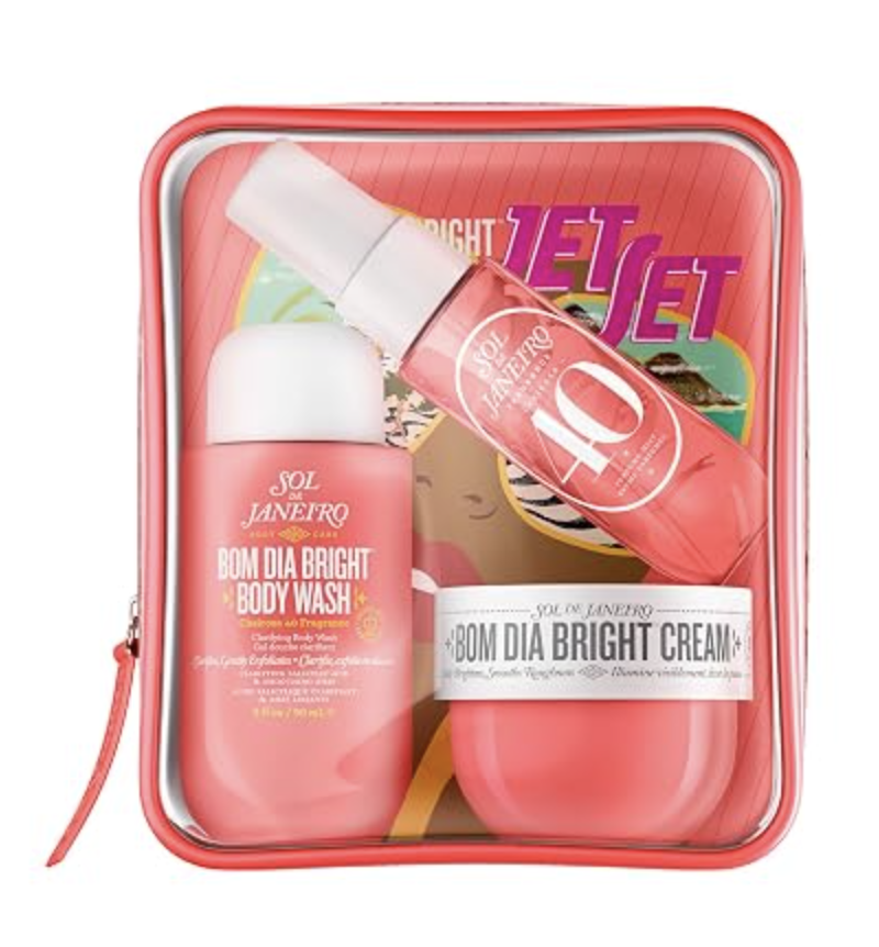 Sol de Janeiro Jet Set travel kit featuring Bom Dia Bright Body Wash, body cream, and Cheirosa 40 fragrance mist packaged in a clear coral zippered pouch.