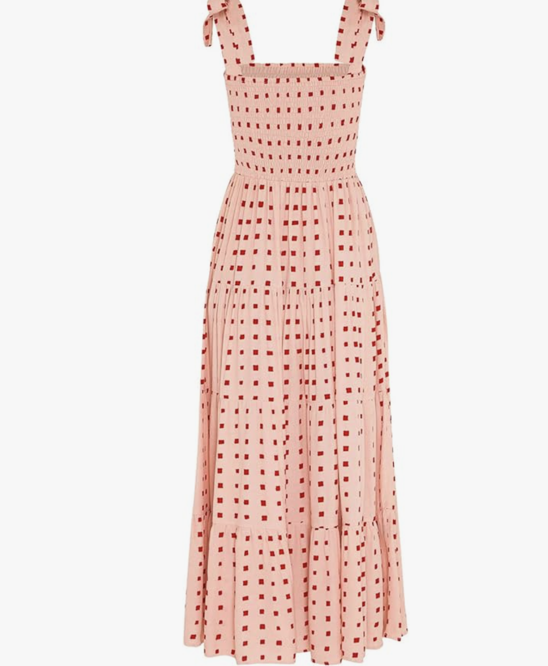 A sleeveless smocked maxi dress in a light pink fabric with a red square-print pattern, featuring a tiered ruffle skirt and a square neckline, styled as a comfortable spring wedding guest look.