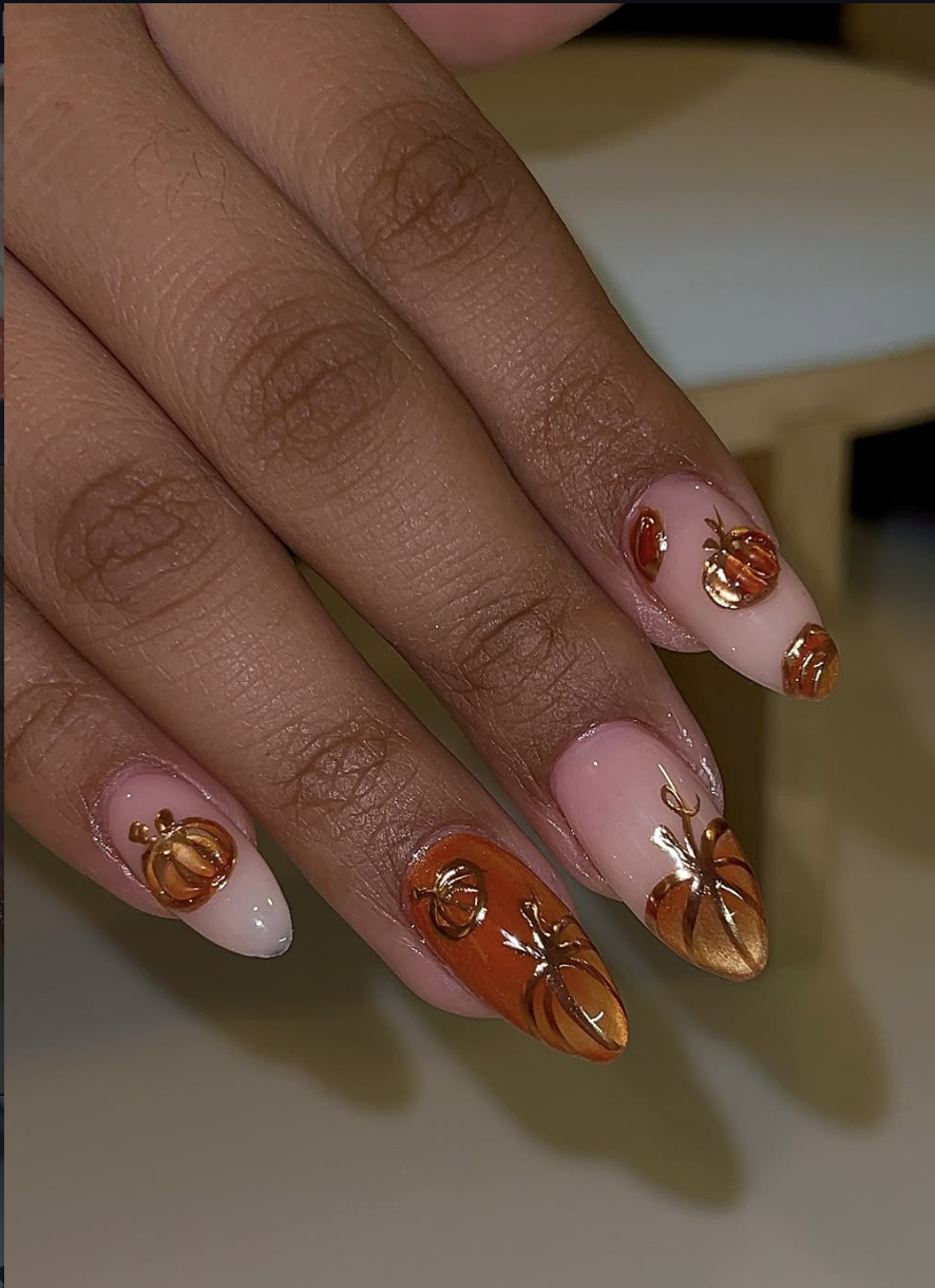 Neutral nails decorated with abstract pumpkins made from copper foil