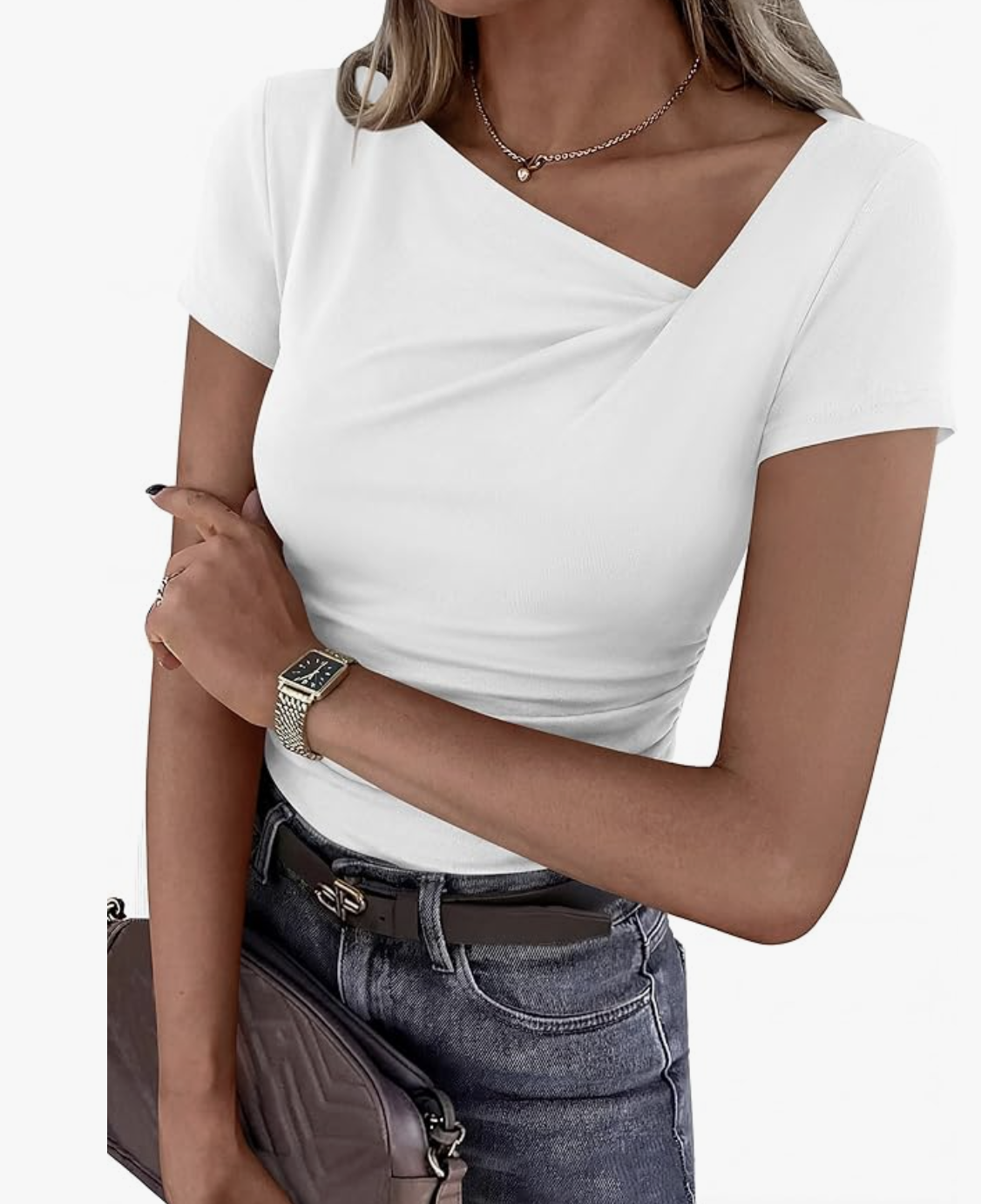 A product shot of a woman wearing a white short-sleeve asymmetrical Y2K top with a diagonal neckline and ruched detail. This fitted top is featured as the ideal non-bulky base layer for the "Urban Drape" blazer outfit formula.