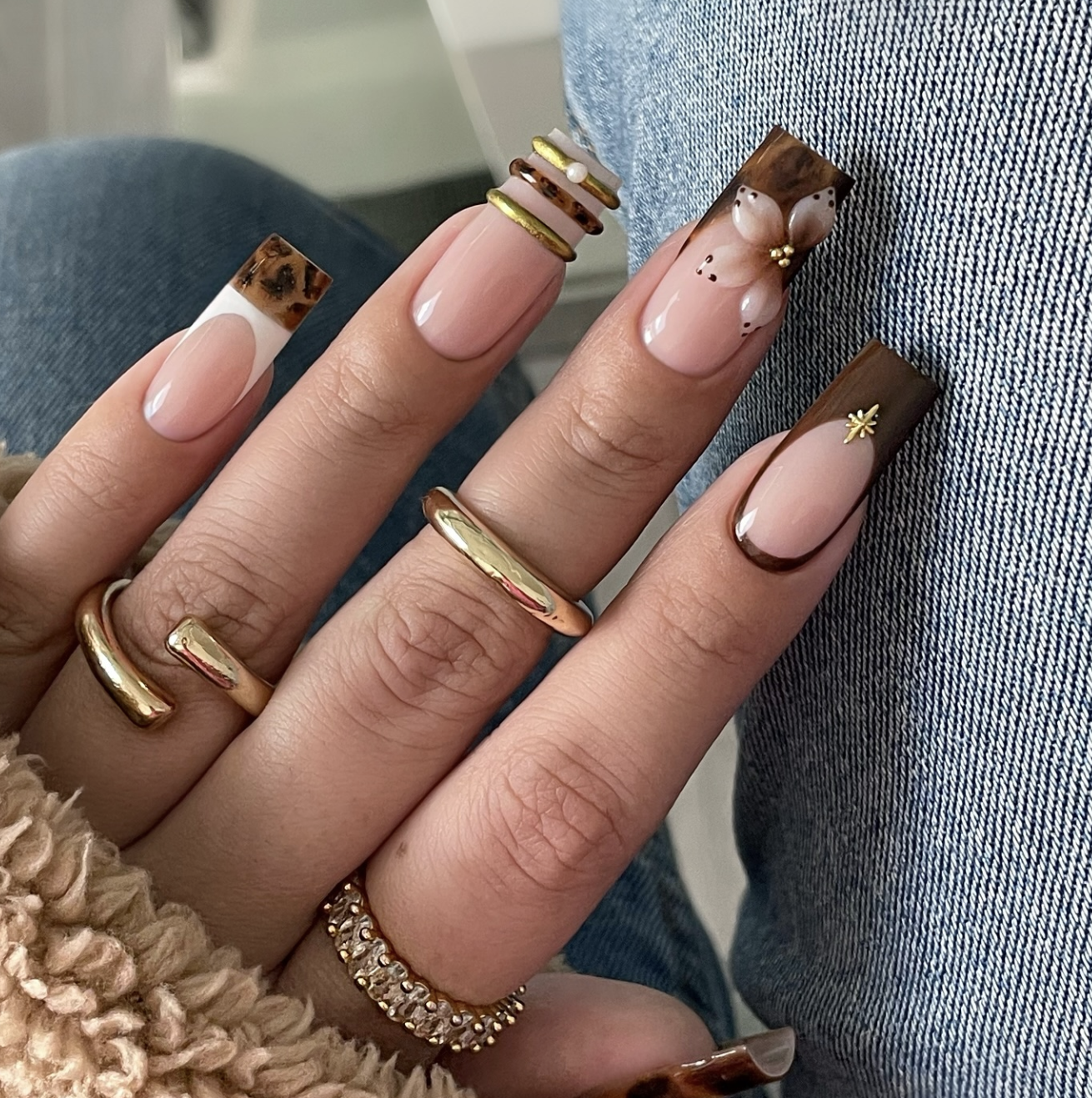 Close-up of brown floral french on neatly manicured hands