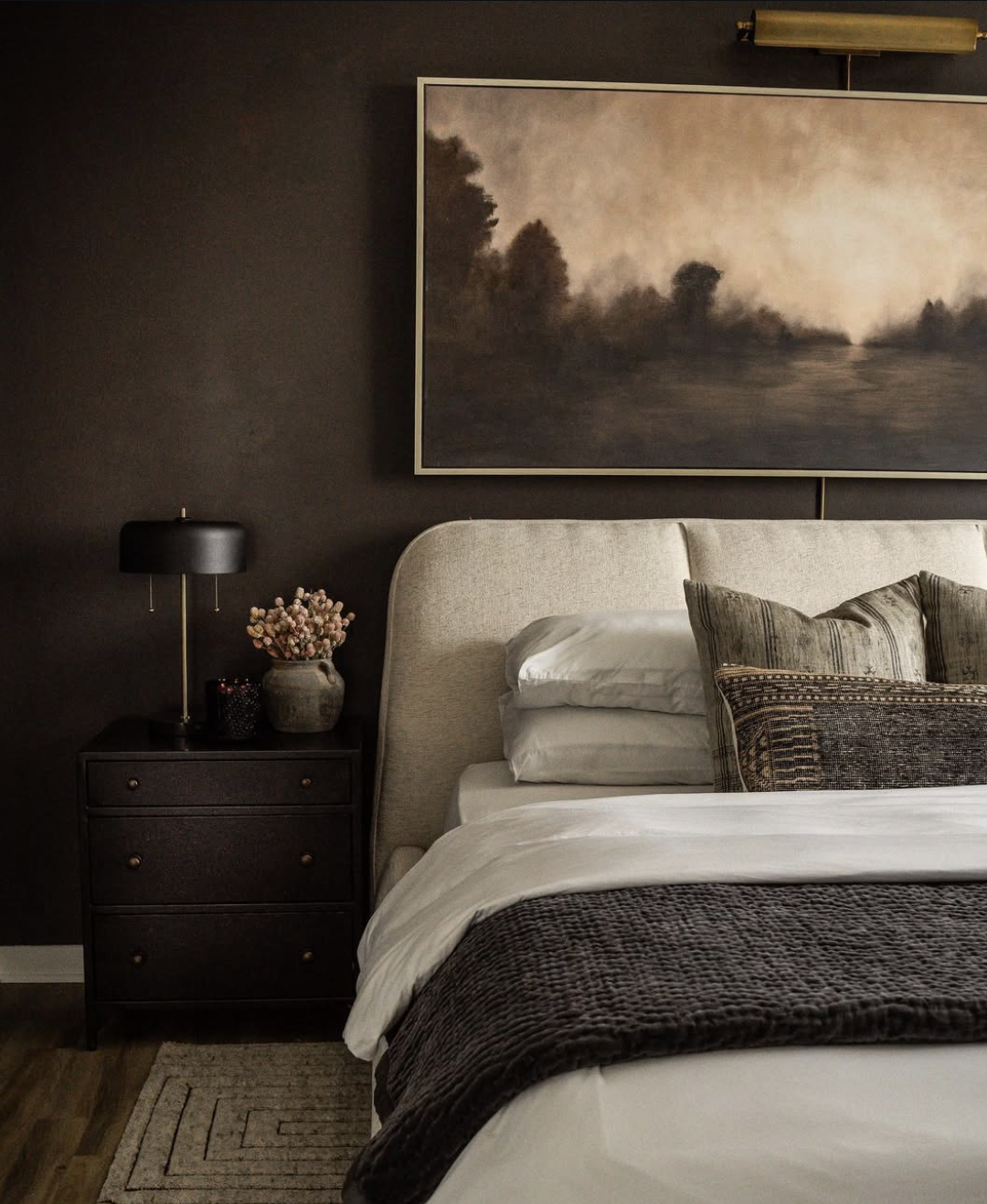 Chocolate brown bedroom paint idea with cream bedding and walnut wood accents