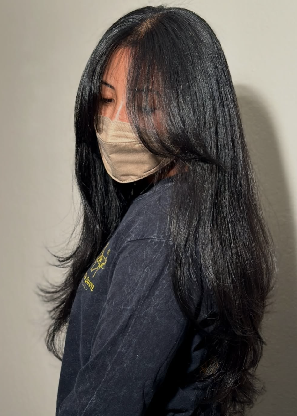 Woman wearing long curtain bangs on straight hair with soft face-framing movement