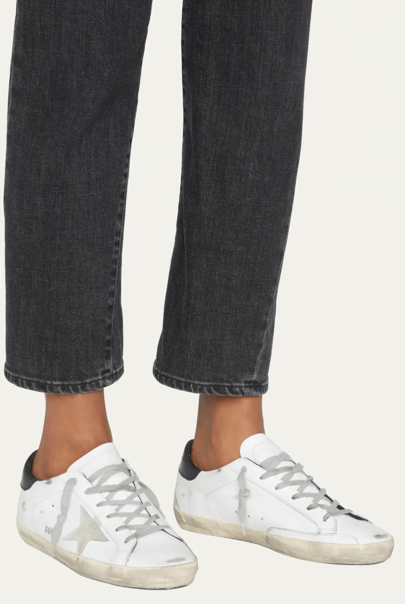 Side view of Golden Goose Superstar Mixed Leather Sneakers in white with a signature gray suede star, black heel tab, and the brand's iconic hand-distressed finish.