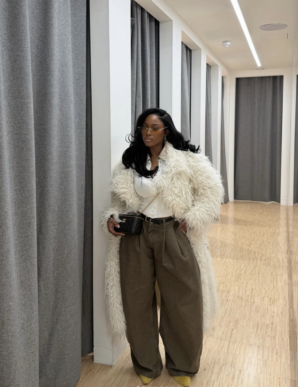 Emerald green wide leg pants paired with a structured leather jacket for an elevated evening outfit.