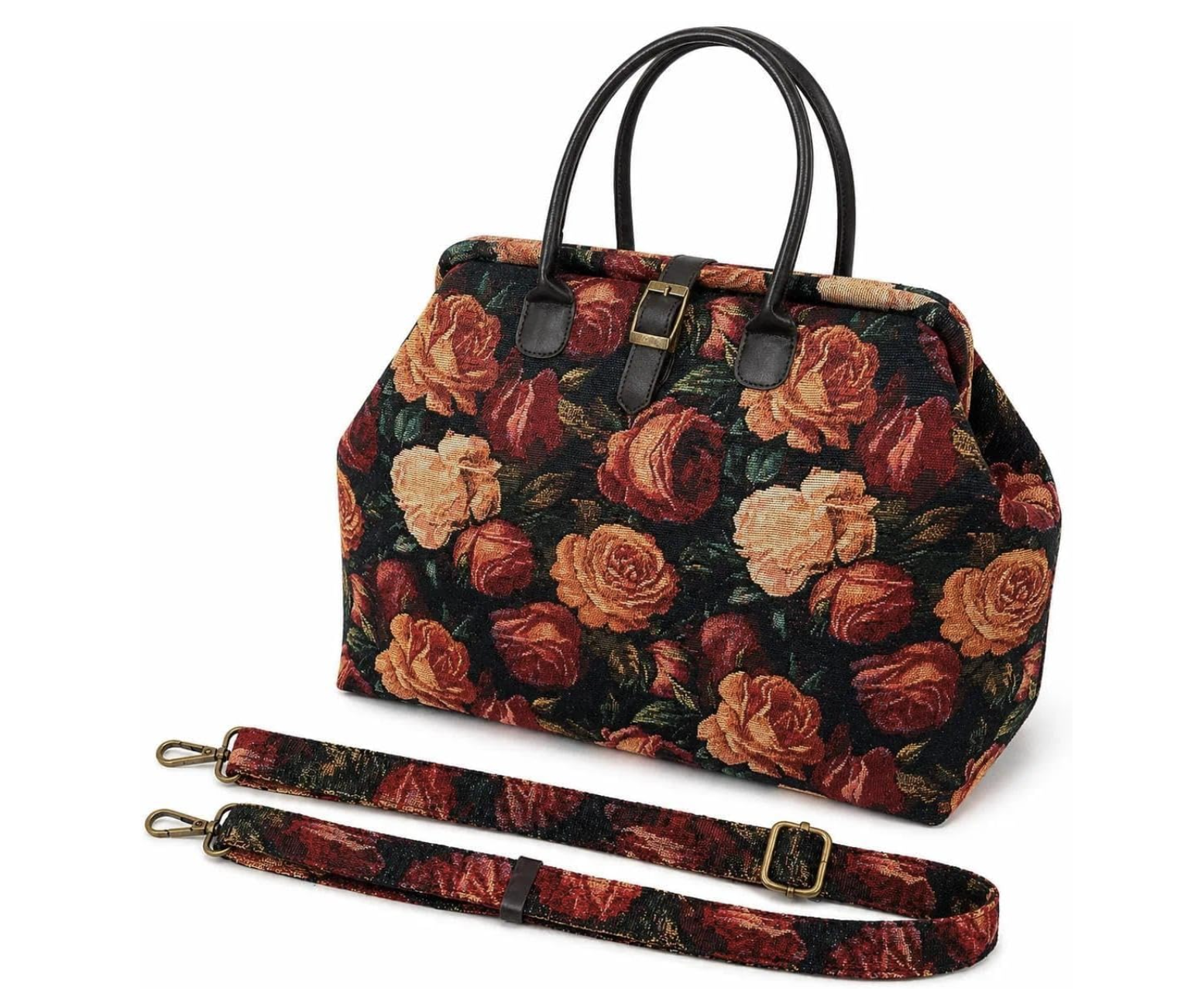 A dark floral tapestry carpet bag with red and cream roses, dark leather handles, gold buckle details, and an adjustable shoulder strap on a white background.