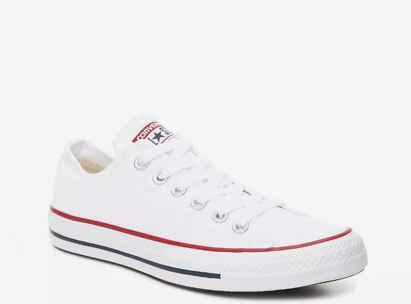 Side view of the classic white Converse Chuck Taylor All Star Low Top sneakers featuring the signature red and blue foxing stripe and durable canvas upper.