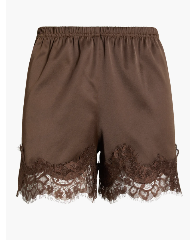 Close-up of chocolate brown satin shorts featuring a matching delicate floral lace trim along the hemline.