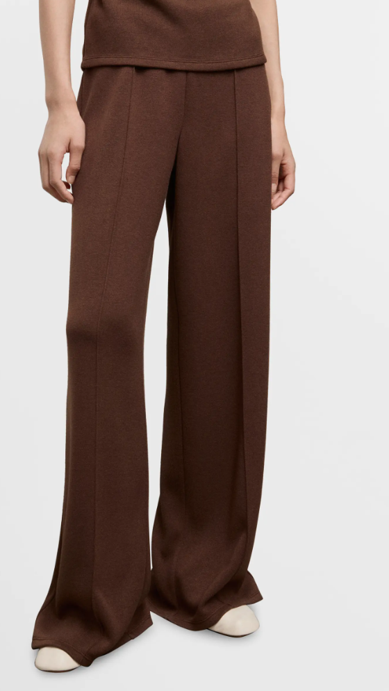 A close-up of dark brown pleated wide-leg trousers from Mango, showing the texture and fit for a neutral outfit.