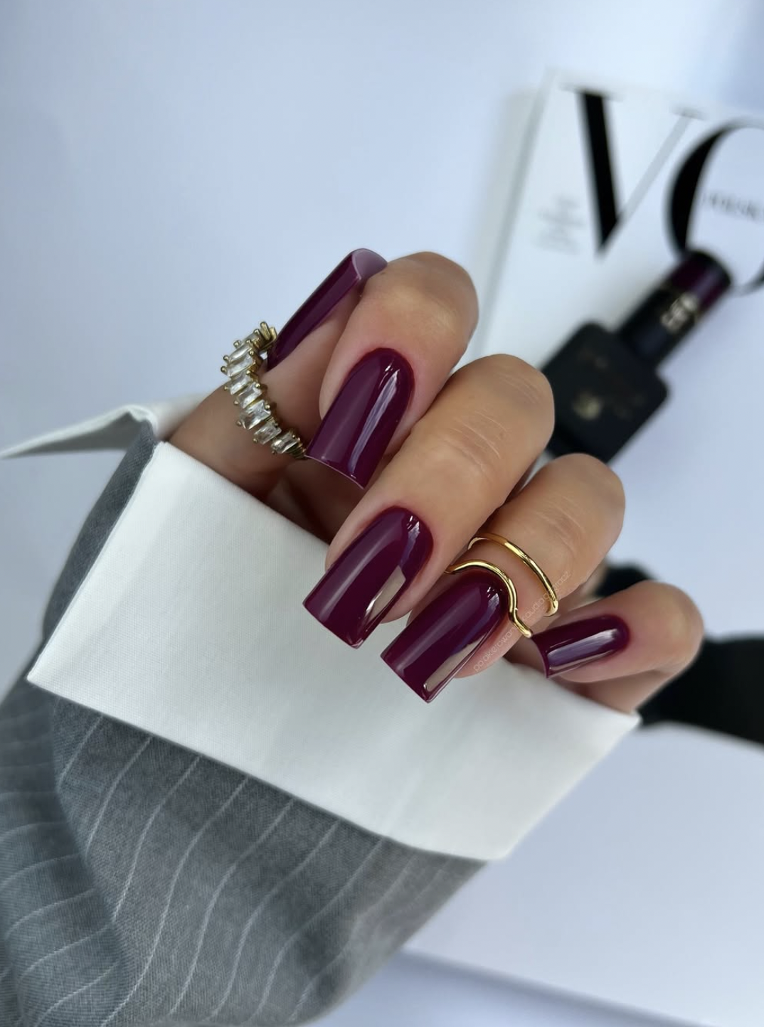 Glossy dark plum manicure on medium oval nails