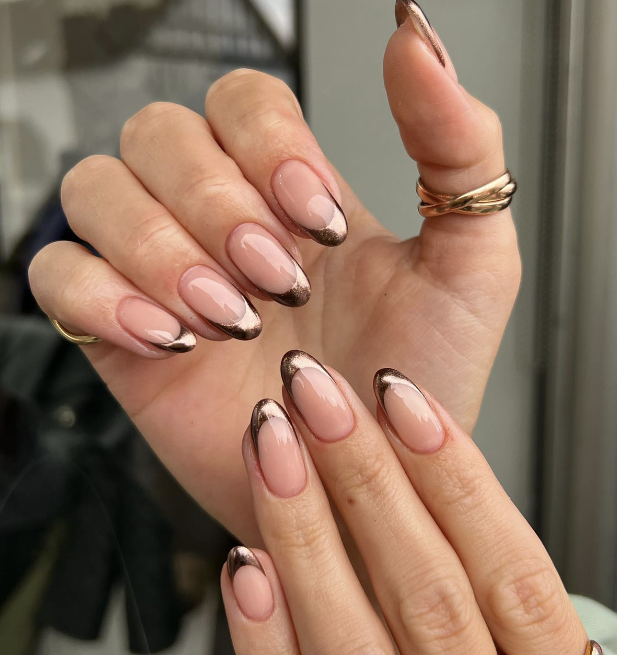 Close-up of copper chrome french on neatly manicured hands