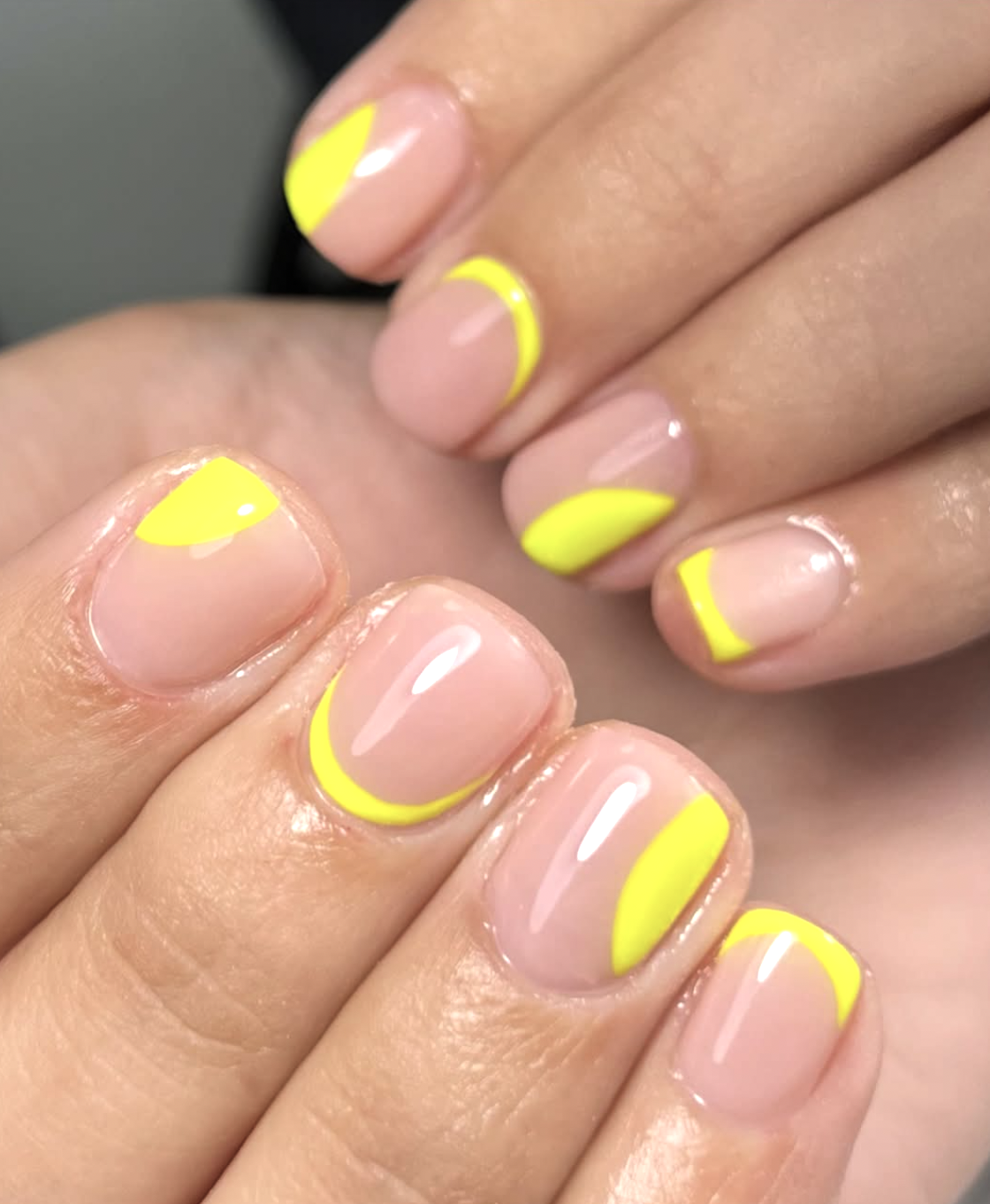 Milky nude nails with thin neon-yellow French tips