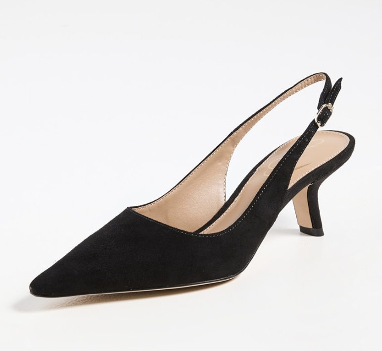 A close-up of a black pointed-toe slingback pump with a modest kitten heel and a sleek, minimalist design.