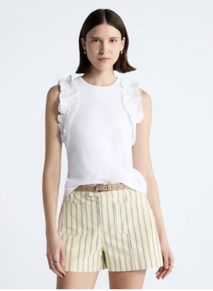 A simple yet stylish tank top featuring feminine ruffle trim details around the edges.