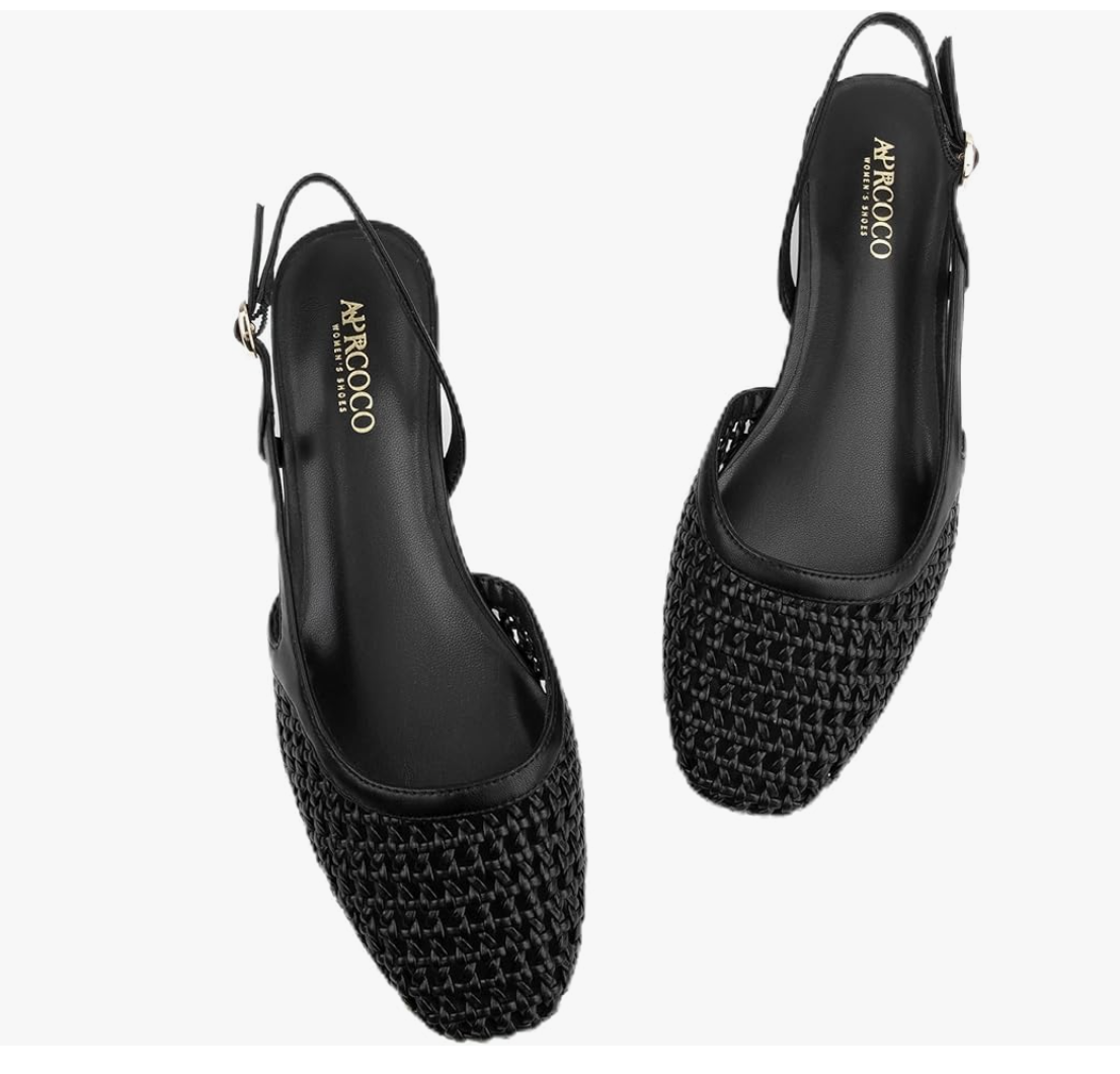 A pair of black woven leather slingback flats with a pointed toe and a thin adjustable heel strap on a transparent background.