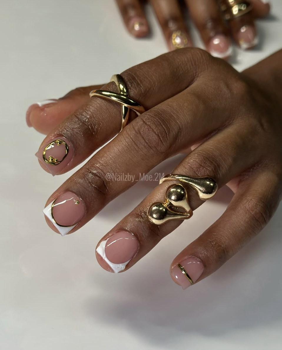 Close-up of gold-lined espresso french on neatly manicured hands