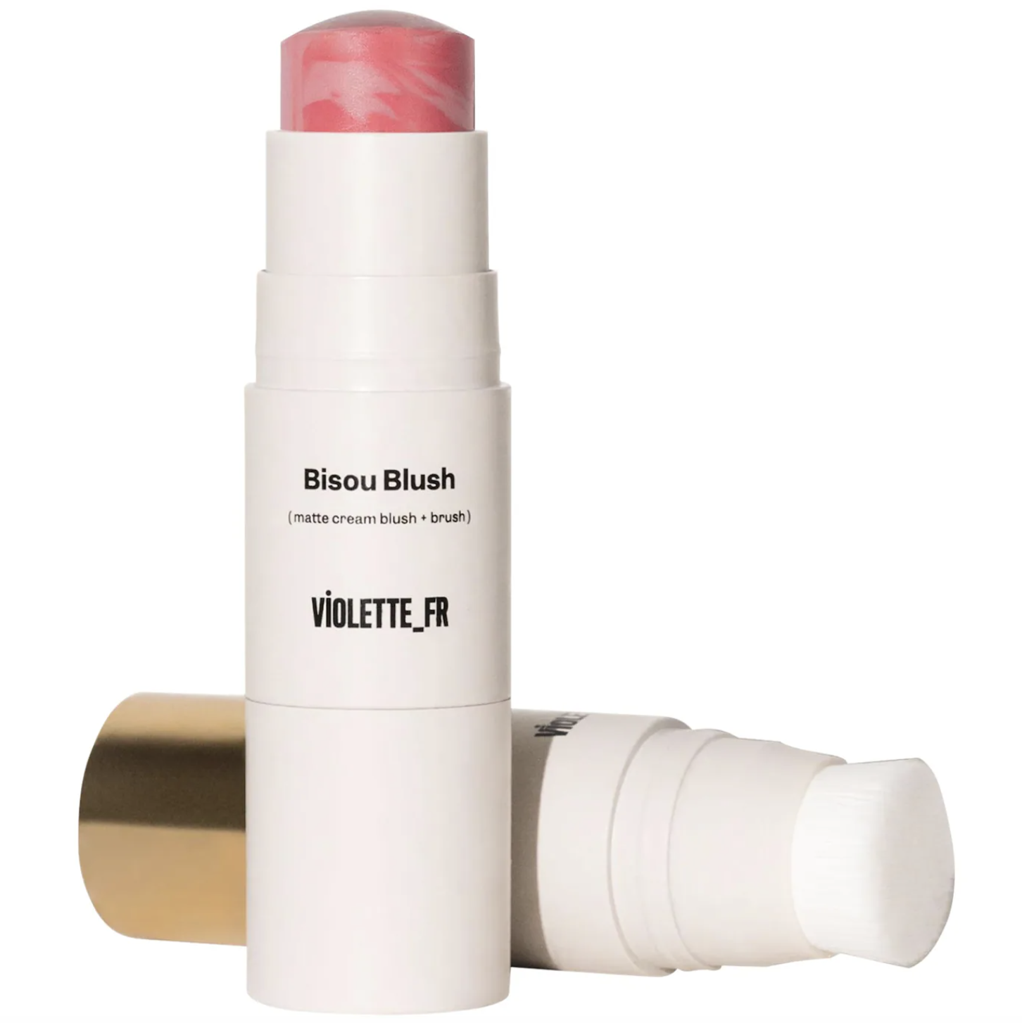 The Violette_FR Bisou Blush stick in the shade Inès, showing the marbled cream-matte formula in a white tube with an attached blending brush and gold accents.