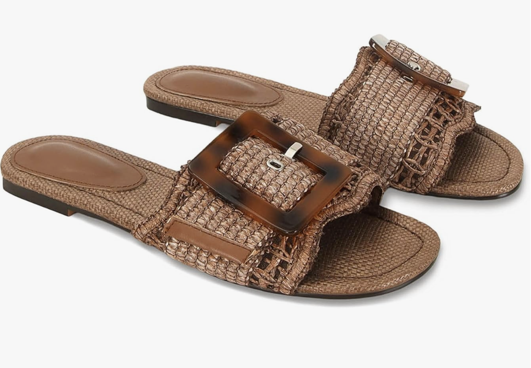 A pair of tan woven braided rattan slide sandals with a tortoiseshell buckle detail, perfect for a casual T-shirt dress outfit.