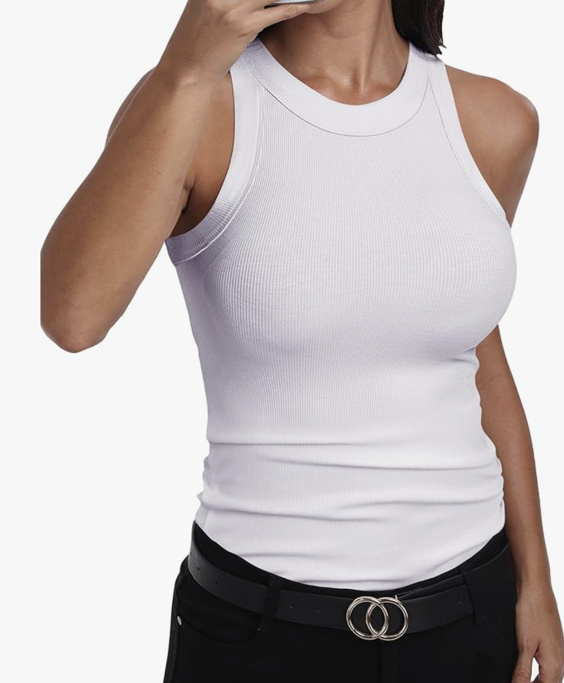 A woman wearing a white sleeveless racerback high-neck tank top tucked into black pants with a black and silver belt.