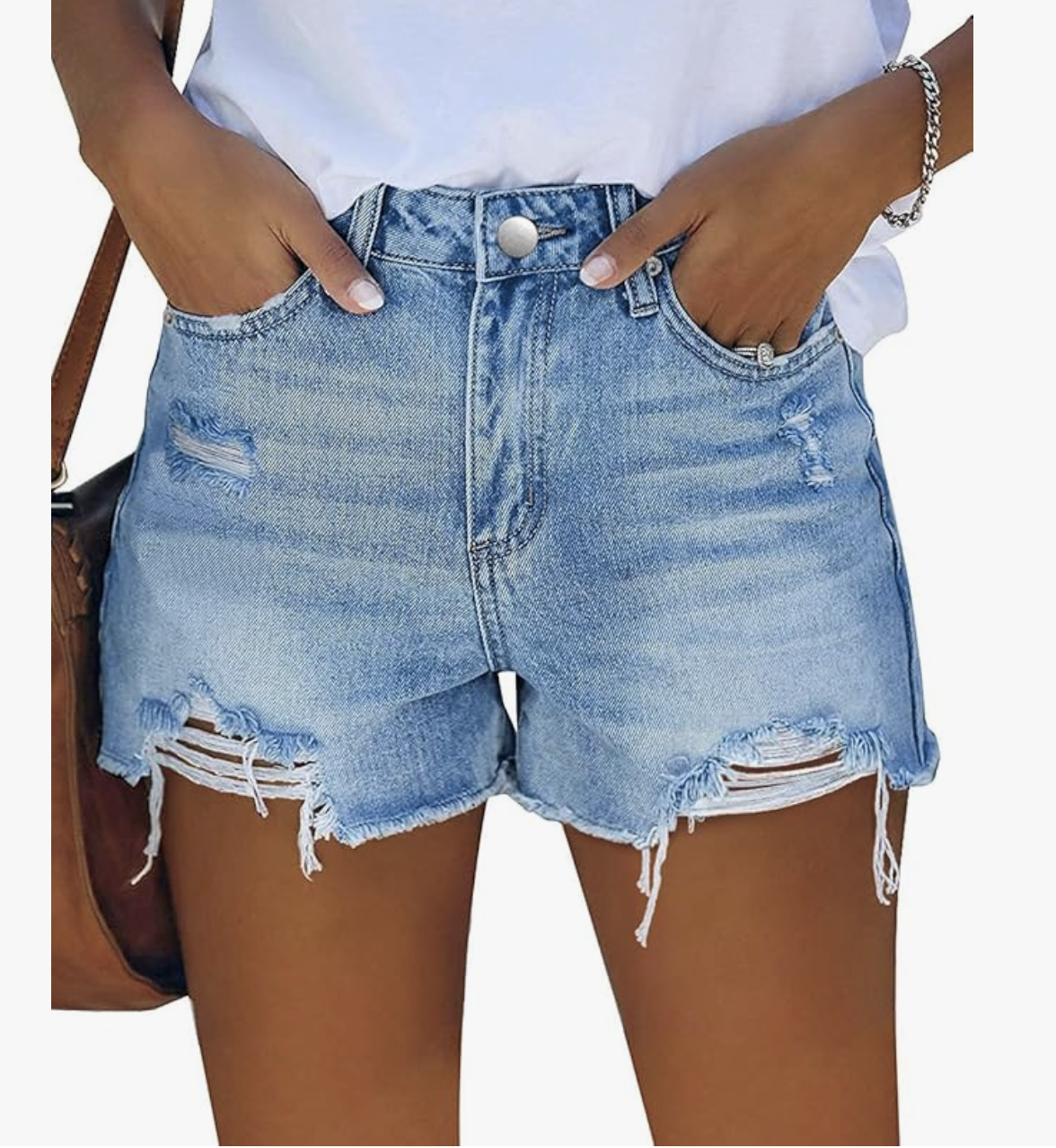 A woman wearing light-wash distressed denim shorts, shown as a versatile and durable option for what to wear on a cruise during port days and excursions.
