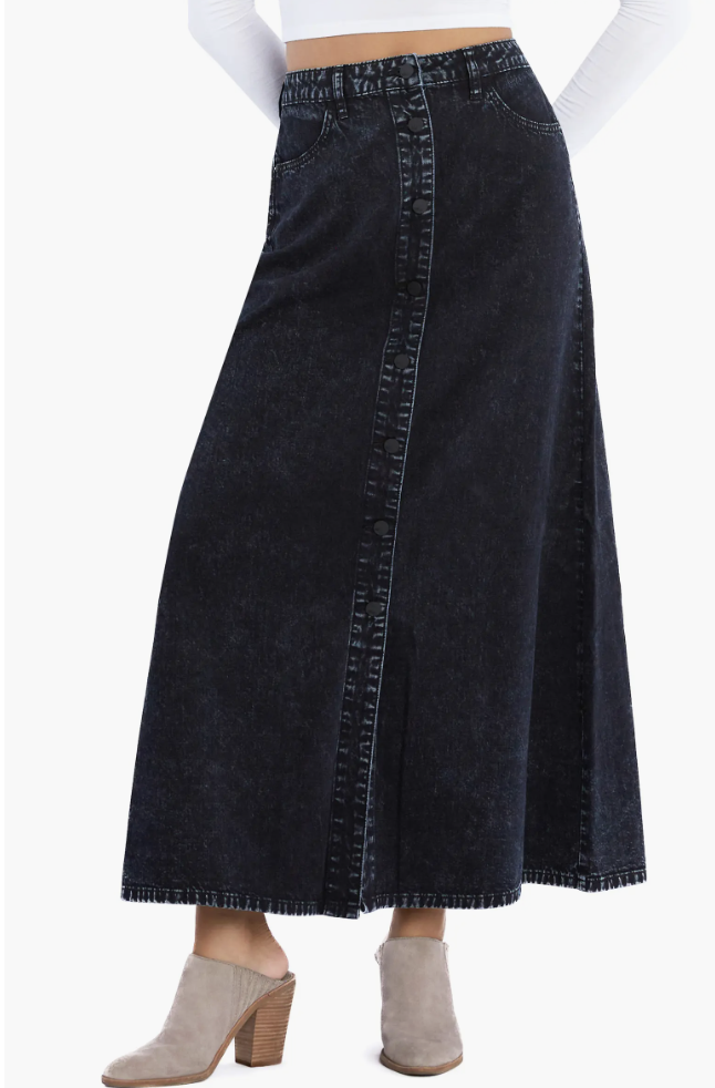 A-line dark wash denim maxi skirt featuring a high-waisted fit, visible vertical seam detailing, and a raw distressed hem.