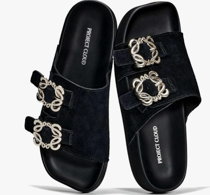 Black suede Project Cloud Velora Slides featuring dual gold-tone jewelry buckles, a plush cushioned insole, and water-resistant genuine leather.